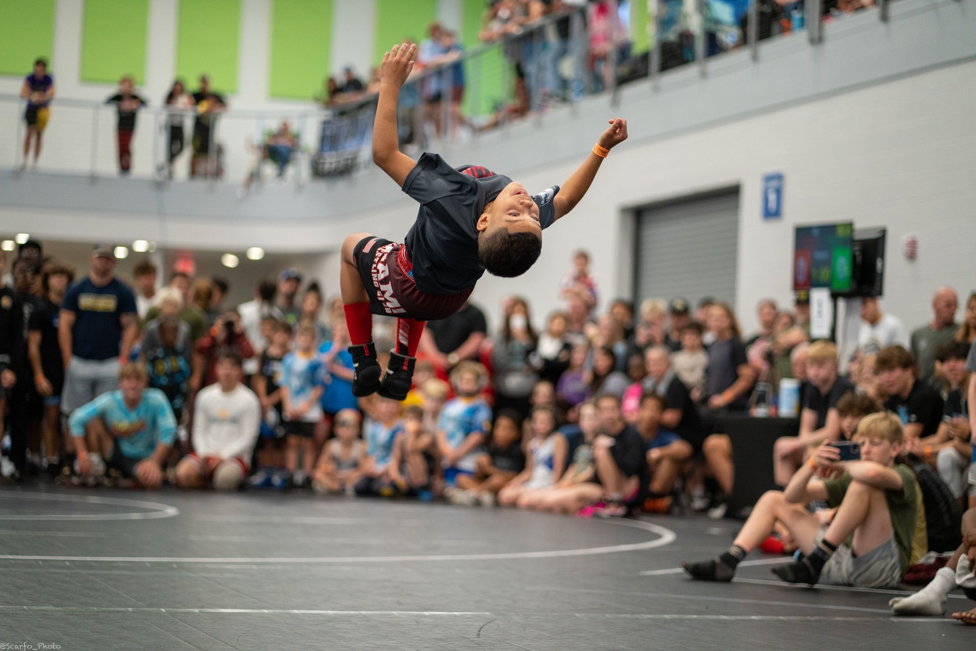 Wrestler competing in the backflip contest at a tournament
